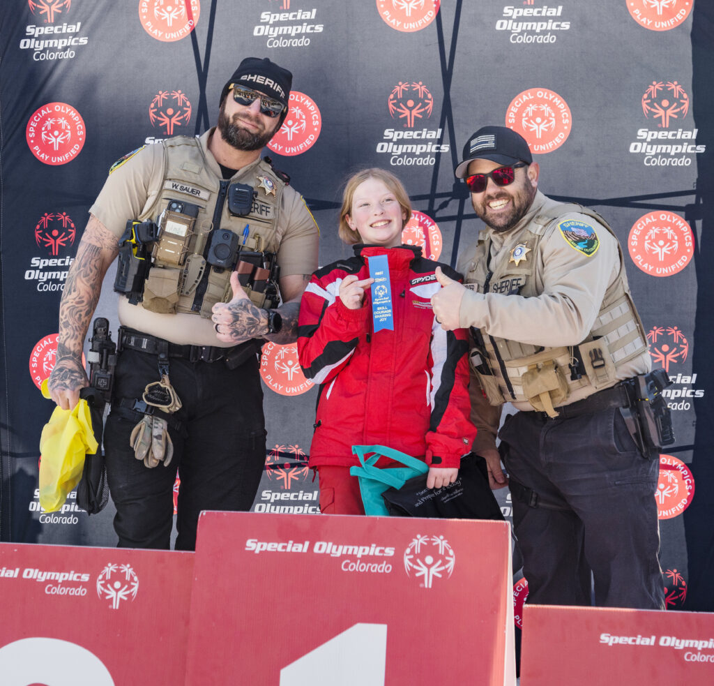 Participant receiving a first place ribbon at the Special Olympics Winter Games